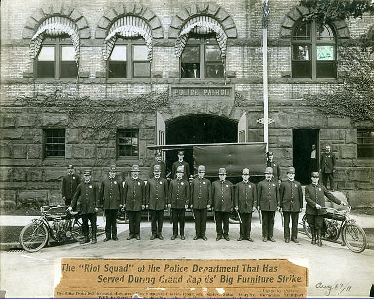 Grand Rapids police officers lined up during the 1911 furniture workers' strike